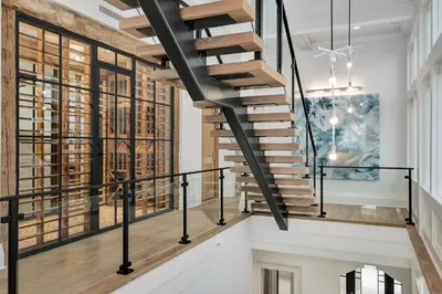 a staircase in a house with black railings at Gulf Front Sanctuary in Santa Rosa Beach
