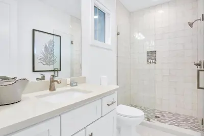 a white bathroom with a sink and a toilet at Aces High in Santa Rosa Beach