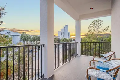 a balcony with chairs and a view of the city at Aces High in Santa Rosa Beach