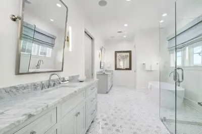 a white bathroom with two sinks and a shower at Emerald Le Luxe in Inlet Beach