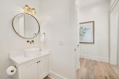 a white bathroom with a sink and a mirror at Emerald Le Luxe in Inlet Beach