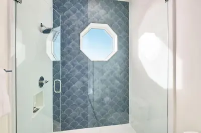 a bathroom with a shower with a glass door at Emerald Le Luxe in Inlet Beach