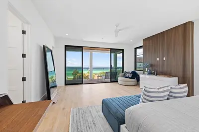 a bedroom with a bed and a view of the ocean at Above & Beyond in Santa Rosa Beach