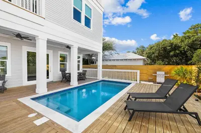 a swimming pool in the backyard of a house at Idyll Time in Santa Rosa Beach