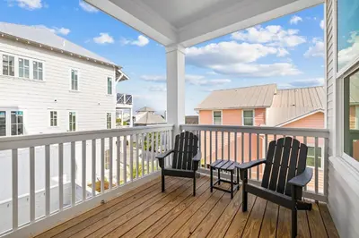 two chairs on a balcony with a view of the ocean at Idyll Time in Santa Rosa Beach