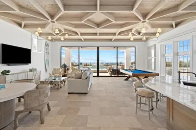 a living room with a ping pong table at Villa Grandeur in Santa Rosa Beach