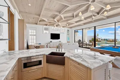 a kitchen with a sink and a pool at Villa Grandeur in Santa Rosa Beach