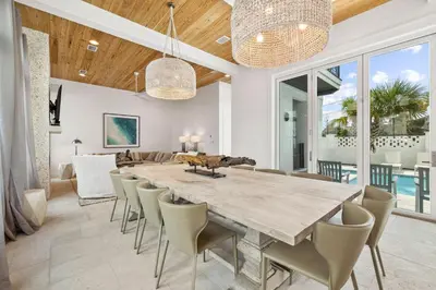 a dining room with a large wooden table and chairs at Seven Palms Reunion in Inlet Beach