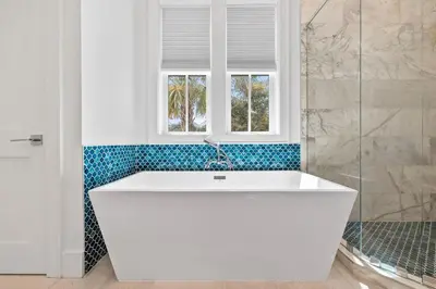 a white bath tub in a bathroom with a window at Seven Palms Reunion in Inlet Beach