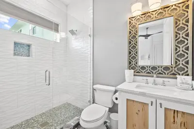a bathroom with a toilet and a sink and a shower at Seven Palms Reunion in Inlet Beach