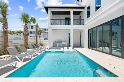 a swimming pool in the backyard of a house at Bullish On Beaches in Inlet Beach