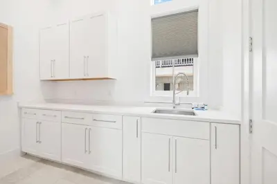 a white kitchen with a sink and a window at Bullish On Beaches in Inlet Beach