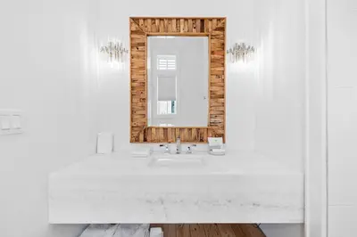 a white bathroom with a sink and a mirror at Seven Palms Retreat in Inlet Beach
