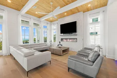 a living room with couches and a tv and a fireplace at Seven Palms Retreat in Inlet Beach