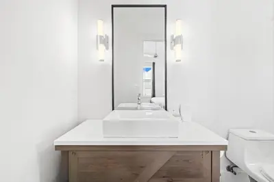 a white bathroom with a sink and a mirror at Seven Palms Retreat in Inlet Beach