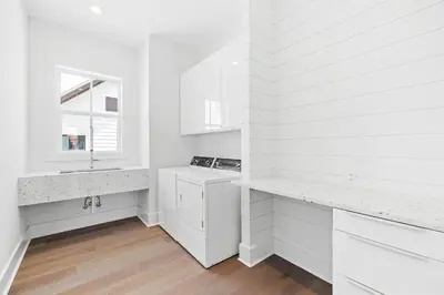 a white kitchen with white cabinets and a sink at Seven Palms Retreat in Inlet Beach