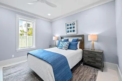 a bedroom with a bed and a window at Emerald View in Inlet Beach