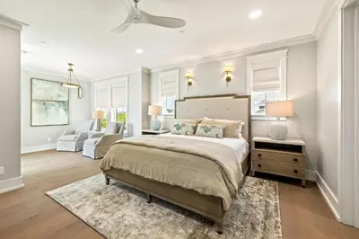 a bedroom with a large bed and a living room at Emerald View in Inlet Beach