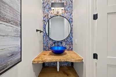 a bathroom with a blue bowl on a table with a mirror at Emerald View in Inlet Beach