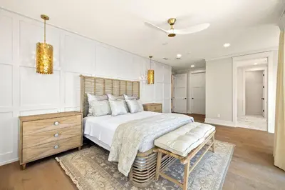 a bedroom with a large bed with a wooden headboard at Emerald View in Inlet Beach