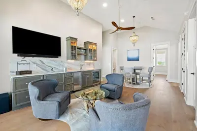 a living room with two chairs and a tv at Emerald View in Inlet Beach