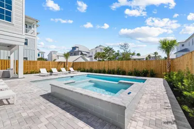 a swimming pool in the backyard of a house at Good Vibrations in Santa Rosa Beach