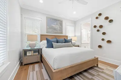 a white bedroom with a bed and a window at Good Vibrations in Santa Rosa Beach