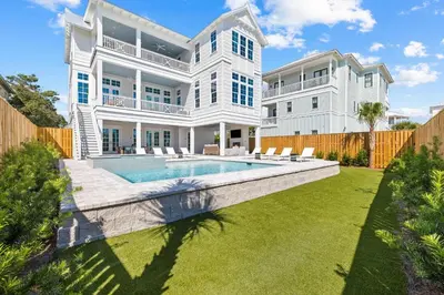 a large white house with a swimming pool at Good Vibrations in Santa Rosa Beach