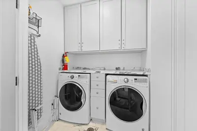 a white laundry room with a washer and dryer at Playa Blanca in Rosemary Beach