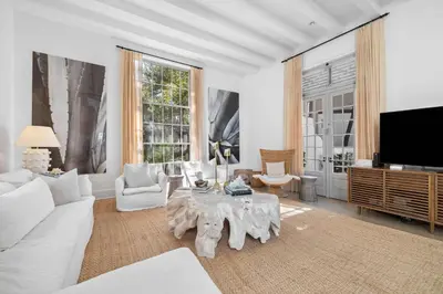 a living room with a white couch and a table at Playa Blanca in Rosemary Beach