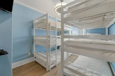 a couple of bunk beds in a room at Beach Please Beach House by Panhandle Getaways in Panama City Beach