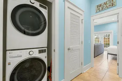 a washer and dryer in a laundry room at Beach Please Beach House by Panhandle Getaways in Panama City Beach