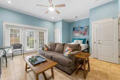 a living room with a couch and a table at Beach Please Beach House by Panhandle Getaways in Panama City Beach