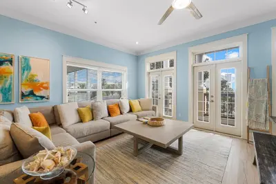a living room with a couch and a table at Beach Please Beach House by Panhandle Getaways in Panama City Beach
