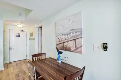 a dining room with a table and a painting on the wall at Shores of Panama 415 condo in Panama City Beach