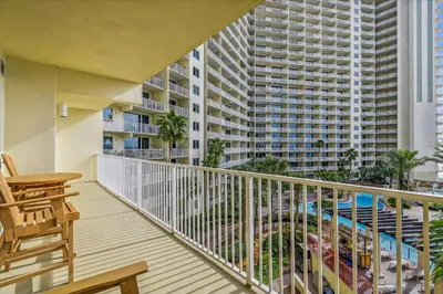 a balcony with a table and chairs and a building at Shores of Panama 415 condo in Panama City Beach