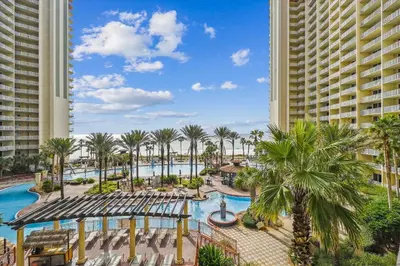 an image of a resort with a pool and palm trees at Shores of Panama 415 condo in Panama City Beach