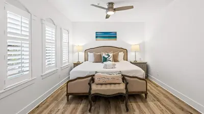a bedroom with a bed and a ceiling fan at Villas at Seagrove A101 - Sunshine Sabbatical in Santa Rosa Beach