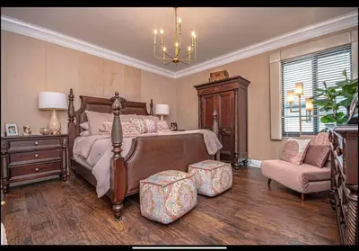 a bedroom with a bed and a couch and a chair at Dancing Dolphins, Watercrest 1803,1804 in Panama City Beach