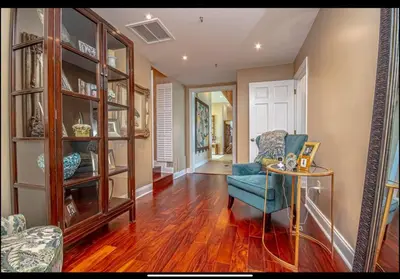 a living room with a blue chair and a table at Dancing Dolphins, Watercrest 1803,1804 in Panama City Beach