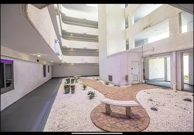 a large room with a bench in a building at Dancing Dolphins, Watercrest 1803,1804 in Panama City Beach