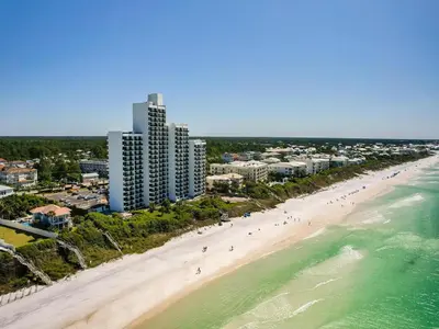 an aerial view of a beach with people on it at One Seagrove Place #507 in Santa Rosa Beach
