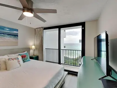 a bedroom with a bed and a view of the ocean at One Seagrove Place #507 in Santa Rosa Beach