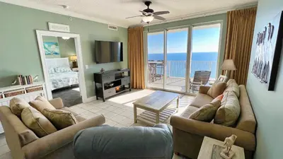 a living room with two couches and a view of the ocean at Tropic Winds 2007 in Panama City Beach