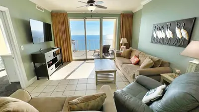 a living room with a couch and a tv at Tropic Winds 2007 in Panama City Beach