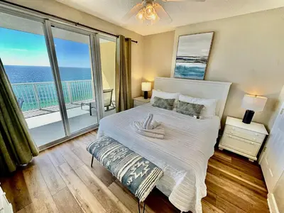 a bedroom with a bed with a view of the ocean at Tropic Winds 1208 in Panama City Beach