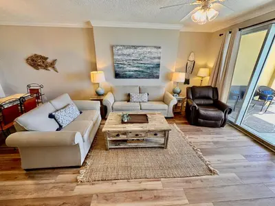 a living room with a couch and a coffee table at Tropic Winds 1208 in Panama City Beach