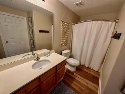 a bathroom with a sink and a toilet and a shower at Tropic Winds 1208 in Panama City Beach