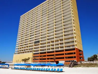 a large building with blue umbrellas in front of it at Tropic Winds 1208 in Panama City Beach