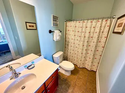 a bathroom with a sink and a toilet and a shower at Tropic Winds 701 in Panama City Beach